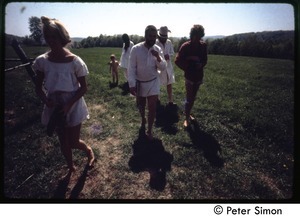 Peter Simon (far right) and others walking through the fields, Tree Frog Farm commune
