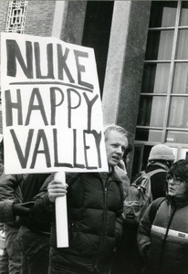 Right wing protester at UMass Amherst with placard reading 'Nuke Happy Valley'