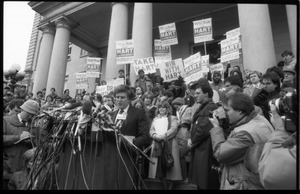 Gary Hart at a microphone-encrusted podium, addressing an crowd after renewing his bid for the Democratic nomination for the presidency