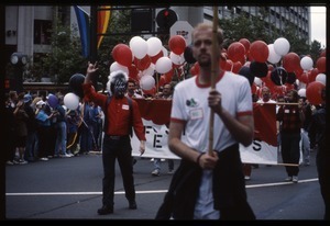 Marchers in the San Francisco Pride Parade with banner for Stop AIDS Project: one with painted face