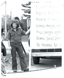 Board of Trustees fee increase demonstration: Charles Bagli holding sign