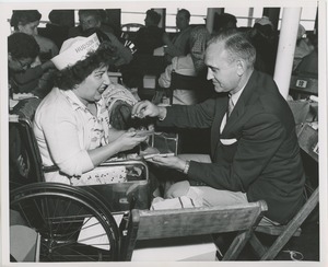 Woman in wheelchair and man with salt at lunch