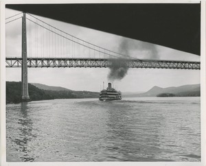 Ship passes under bridge