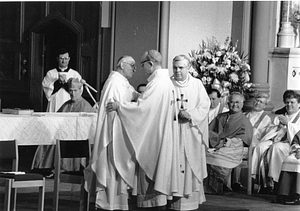 Archbishop Bernard F. Law at altar with unidentified priests