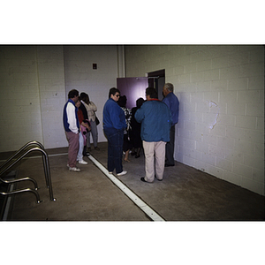 Group surrounding pool room entrance