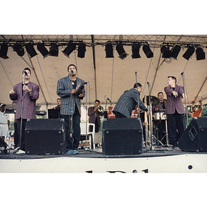 The four front men of the band on stage at the Festival Puertorriqueño