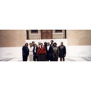 Eleven people pose together at a town hall meeting