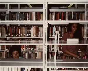 Two Students Shelving Books.
