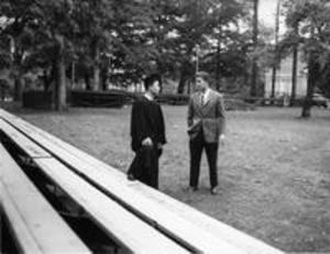 Graduate at empty commencement stage, 1958