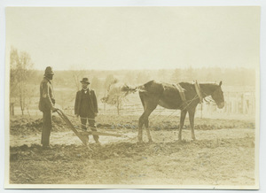 Booker T. Washington with student driving plow