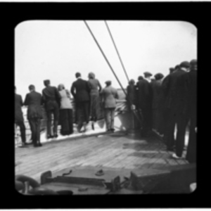 Passengers line the ship railing