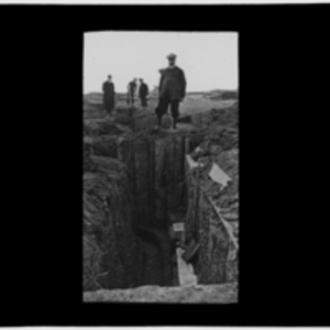 Men standing at trench edge