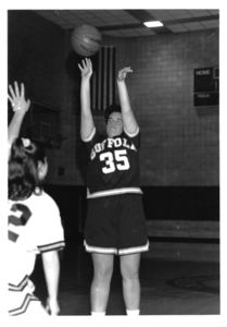 Suffolk University women's basketball player Noreen McBride shooting during basketball game, 1996