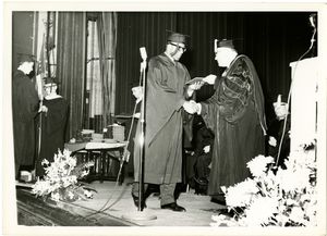 Student receives his diploma at the 1963 Suffolk University commencement