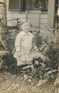 Ernest A. Swan, Jr., in backyard among ferns