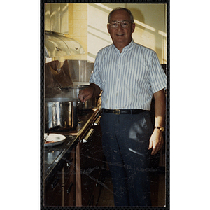 A male staff member posing in the kitchen