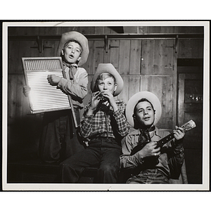 Three Bunker Hillbillies pose with their instruments, including a washboard, whistle and ukulele