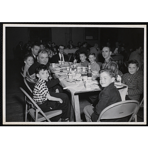 Men and boys sit a table during a Dad's Club banquet
