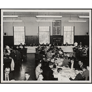 Boys' Club officers and guests sit at tables in a hall at a Church Day event