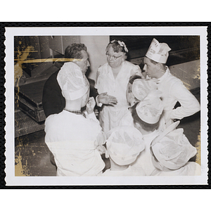 Members of the Tom Pappas Chefs' Club confer with a man and woman