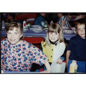 Two girls and a boy standing at a table at a Boys & Girls Club Awards Night