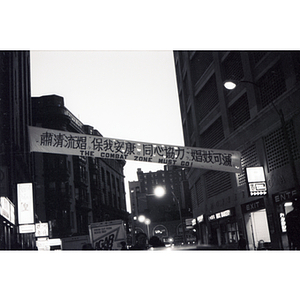 Banner in Chinatown reads, "The Combat Zone Must Go!" at an evening demonstration in which Chinatown residents protest against the encroaching red-light district in Boston