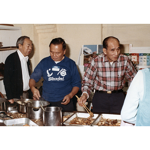 Chinese Progressive Association members serving food at a community dinner