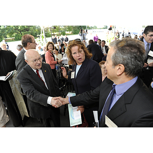 Dr. George J. Kostas shakes hands with Al Spagnoli at the groundbreaking ceremony for the George J. Kostas Research Institute for Homeland Security