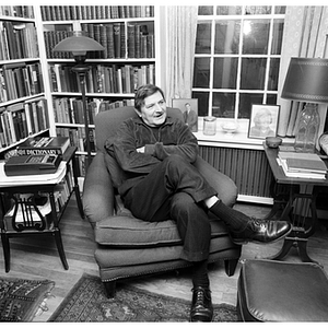 Rudolph Morris poses in his home library