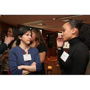 Melanie Arvajo converses with a woman at a Torch Scholars event