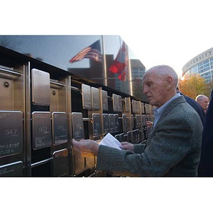 A man looks at a plaque at the Veterans Memorial dedication ceremony