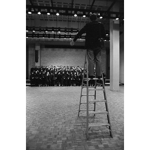 Photographer on a ladder taking a picture of the Law School's Class of 1985
