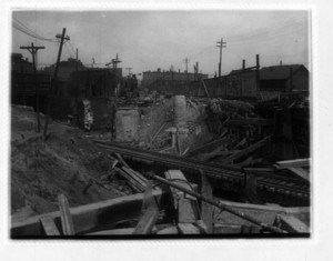 View of railroad tracks going through construction of wood beams