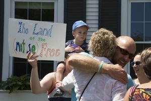 Pro-immigration protesters and signs outside the Chatham town offices building, one with a sign reading 'The land of the (not so) free' : taken at the 'Families Belong Together' protest against the Trump administration's immigration policies