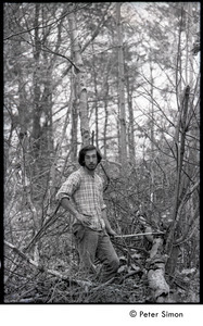 Marty Jezer in the woods, axe in hand: Packer Corners commune
