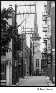 View down a narrow street of church and overhead wires, York, Pa.