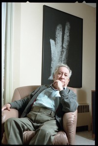 Fine art photographer Aaron Siskind: seated in a armchair in his living room