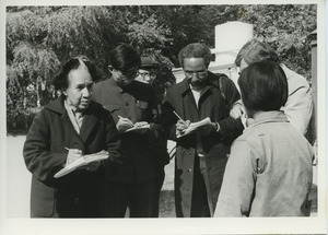 Shirley Graham Du Bois, David Graham Du Bois and three unidentified men interviewing an unidentified woman