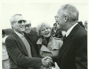 Joseph D. Duffey standing outdoors with Paul Newman, Joanne Woodward