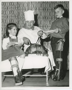 Young clients eating turkey at Thanksgiving celebration