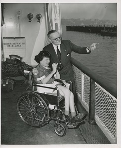 Woman in wheelchair and old man at boat rail