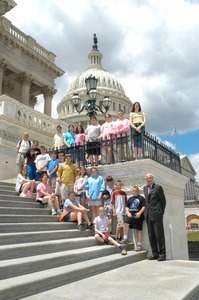 Congressman John W. Olver (far right) with visiting group, posed on the steps of the United States Capitol building