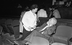 Mayor Kevin H. White speaking with an unidentified woman at the Strand Theatre