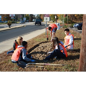 Teen volunteers rest after planting daffodils