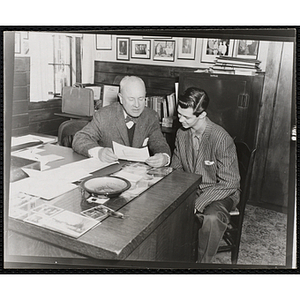 Arthur T. Burger, Executive Director of the Boys' Clubs of Boston, and Richard J. O'Neil, Boy Ambassador, looking at a document together