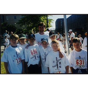 A man poses with a group of boys at the Battle of Bunker Hill Road Race