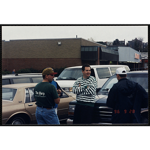 Four men stand in a parking lot during the Charlestown Bike Race