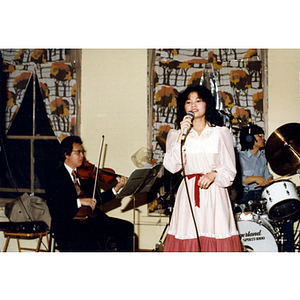 Singer performing at a Chinese Progressive Association party