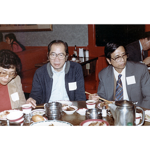 Members of the Chinese Progressive Association eat at a restaurant table during a reception for the Consul General of Guangdong Province
