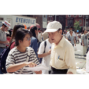 Woman distributes fliers at August Moon Festival